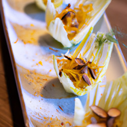 Appetizer: United States – Shaved Fennel and Orange Endive Cups with Olive and Almond Parsley-Lemon-Garlic Topping recipe